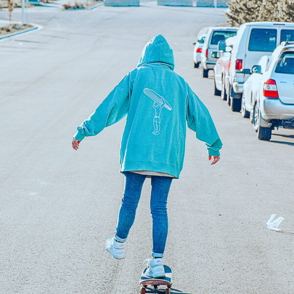 A skater girl in the teal surfer hoodie.